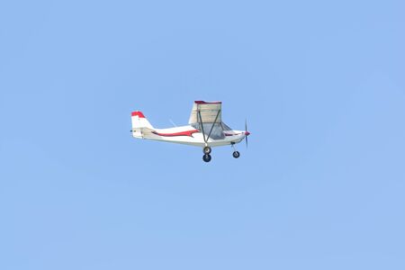 A small pleasure plane flying in the blue sky