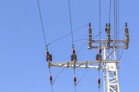 Close-up of a power line against the blue sky