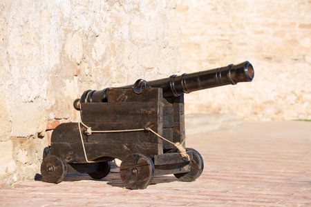 Antique cannon on a brown wooden carriageの写真素材