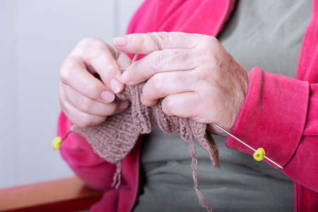 Close-up of womens hands knitting with needles
