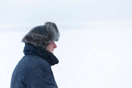 A man in a flight jacket in a snowfallの写真素材