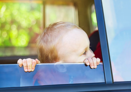 A little boy looking out of the carの写真素材