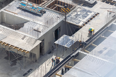 Laying of formwork for filling floors between floors during the construction of a multistory residential buildingの写真素材
