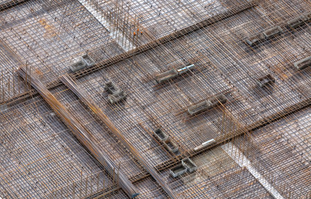 Reinforcing mesh laid on a base for pouring concrete to create a monolithic floor between the floors of a high-rise buildingの写真素材