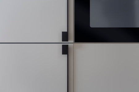 Matte-gray facades of built-in kitchen furniture with stylish black handlesの写真素材