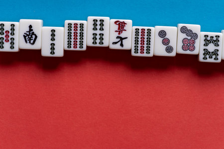 Mahjong tiles on a red and blue backgroundの写真素材