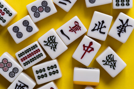 Mahjong tiles lined up on a yellow background