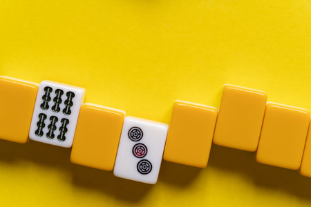 Mahjong tiles lined up on a yellow backgroundの写真素材