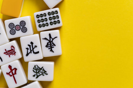 Mahjong tiles lined up on a yellow backgroundの写真素材