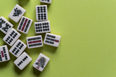 Mahjong tiles lined up on a yellow-green background