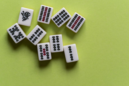 Mahjong tiles lined up on a yellow-green background