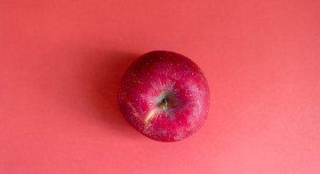 Delicious apples on a red backgroundの写真素材