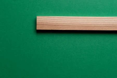 Wooden board placed on a green backgroundの写真素材