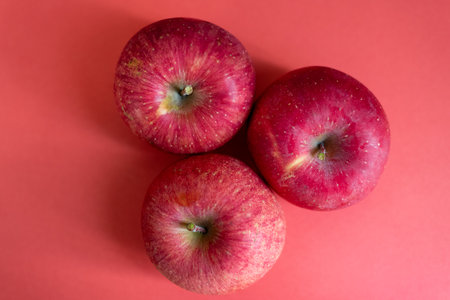Delicious apples on a red backgroundの写真素材