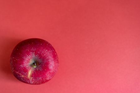 Delicious apples on a red backgroundの写真素材