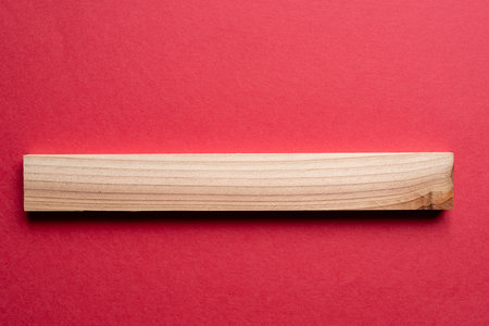 Wooden board on a red background