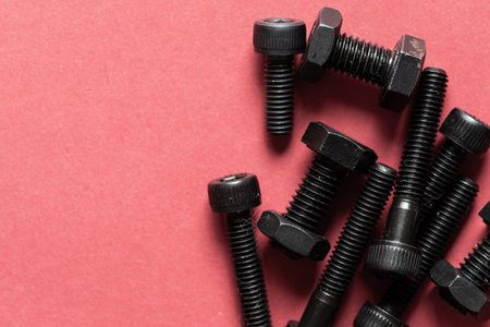 Hexagonal bolt on a red backgroundの写真素材