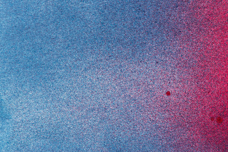 Red and blue spray paint backgroundの写真素材
