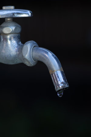 Drops of water falling from a faucet