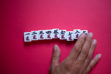 People touching mahjong tilesの写真素材