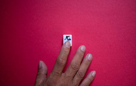 People touching mahjong tilesの写真素材