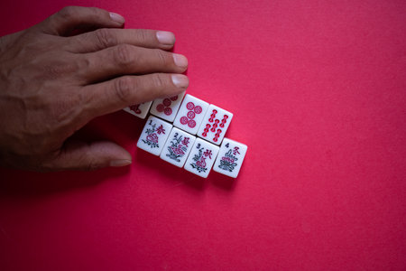 People touching mahjong tilesの写真素材