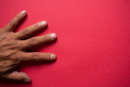 Hands on a red backgroundの写真素材