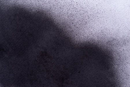 Black spray paint on a white backgroundの写真素材