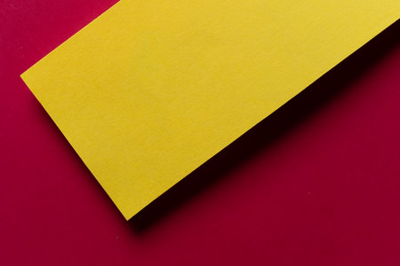 Overlapping red and yellow construction paperの写真素材