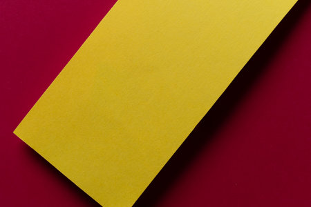 Overlapping red and yellow construction paperの写真素材