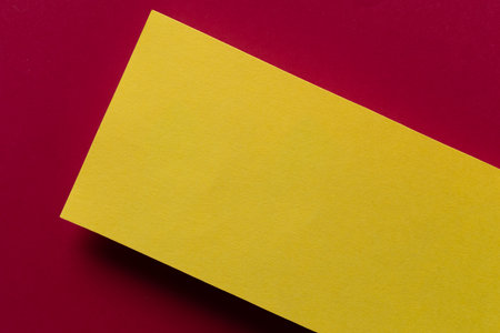 Overlapping red and yellow construction paperの写真素材