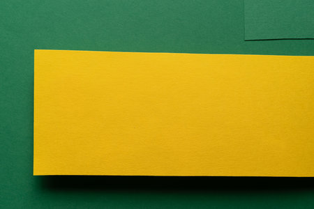Overlapping green and yellow construction paperの写真素材