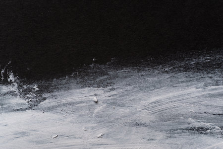 White paint on black construction paperの写真素材