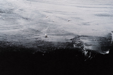 White paint on black construction paperの写真素材