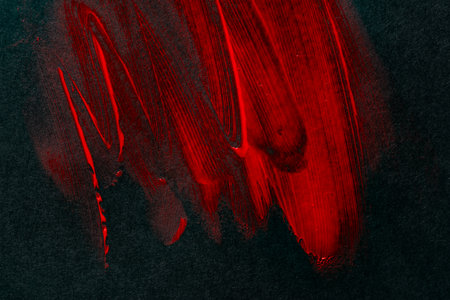 Red paint on black construction paperの写真素材