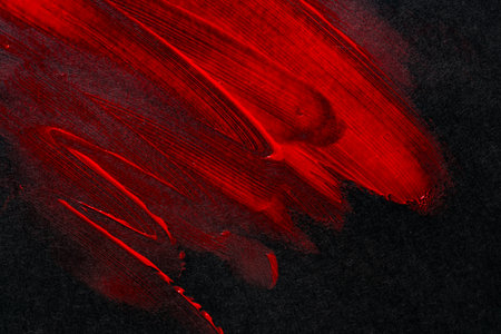 Red paint on black construction paperの写真素材