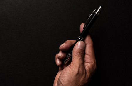 The hand of a person holding a ballpoint penの写真素材
