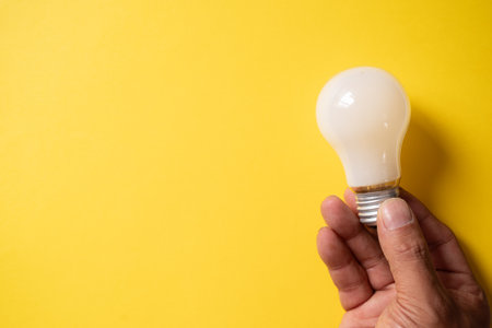 Person holding a light bulbの写真素材