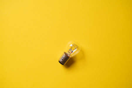 Light bulb on a yellow backgroundの写真素材