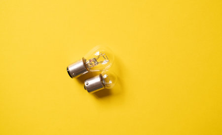 Light bulb on a yellow backgroundの写真素材
