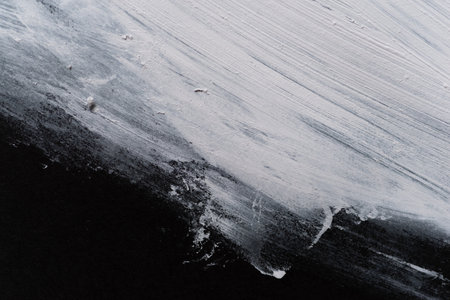 White paint on black construction paperの写真素材