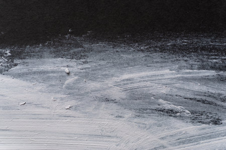 White paint on black construction paperの写真素材