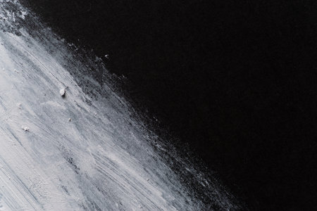 White paint on black construction paperの写真素材