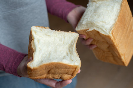 A person holding soft bread