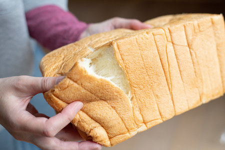 A person holding soft bread