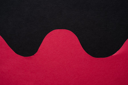 Overlapping wavy red and black construction paper