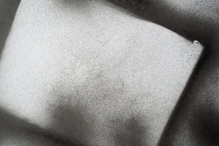 Black spray paint on a white backgroundの写真素材