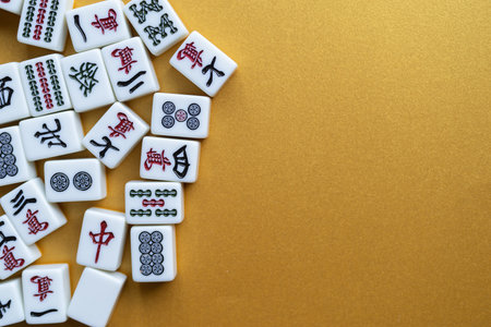 Mahjong tiles lined up on a golden backgroundの写真素材