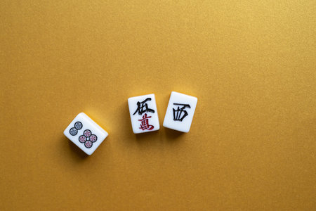 Mahjong tiles lined up on a golden background