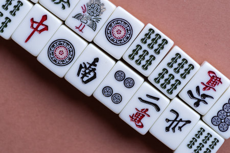 Mahjong tiles lined up on a light backgroundの写真素材